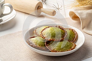 Thai pancake, Deep Fried Rice Flour Pandan Flavour in white plate. photo