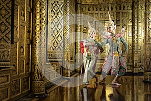 Thai pantomime actresses Sita and Rama are flirting with each other. In the area of a beautiful golden Thai style house