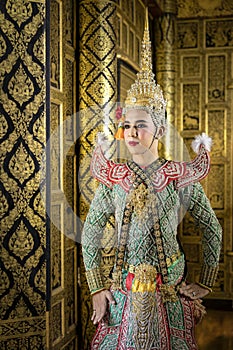 Thai pantomime character In the role of Rama Standing at the house of ancient Thai style, golden beauty