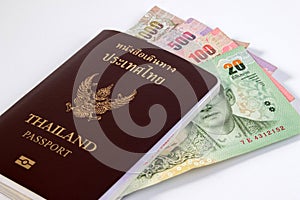 Thai Passport with Thai money banknote isolated on white.