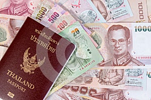 Thai Passport with Thai money banknote on Thai money background.