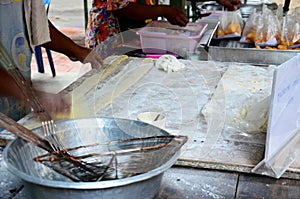Thai people cooking deep-fried doughstick or Youtiao