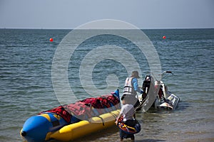 Thai people and foreign travelers travel visit play swimming wave water in sea and ride playing jetski banana boat in ocean of