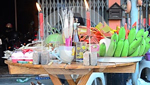 Thai people prepare and putting Sacrificial offering food on wooden table for pray to god