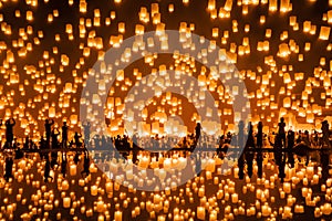 Thai people release sky floating lanterns or lamp to worship Buddha`s relics with reflection. Traditional festival in Chiang mai,