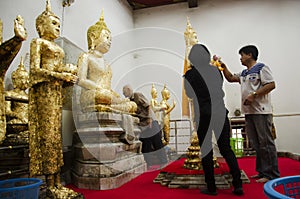 Thai people respect praying and gild cover with gold leaf on Luang Pho Ban Laem