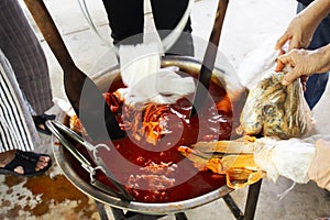 Thai people study learning batik ikat and tie dye natural orange color from boil Bixa orellana achiote in handmade studio