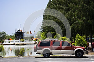 Thai people traveler drive stop vehicle in car parking for travel visit and respect praying blessing wish buddha statue holy