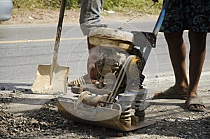 Thai people use soil compactors in construction site working and