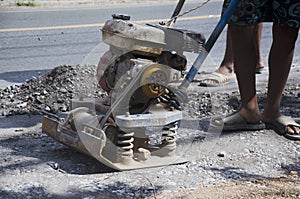 Thai people use soil compactors in construction site working and