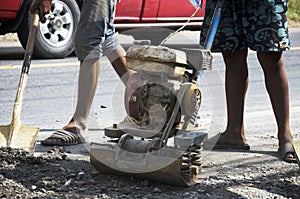 Thai people use soil compactors in construction site working and