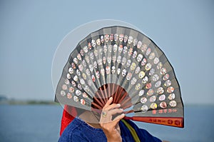 Thai people waving wooden fans on boat go to Donsawan island
