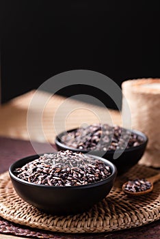 Thai purple glutinous rice grain in a black bowl