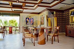 Thai restaurant interior with tables, chairs and shisha at resort