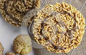 Thai rice cracker or Kaotaen topped with cane sugar on black background. It made of sticky rice. Desert ,snack concept