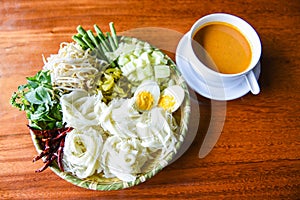 Thai rice noodles - Close up Thailand food vermicelli noodle boiled eggs and fresh vegetables on plate with curry soup bowl served