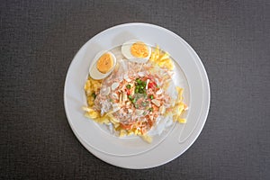 Thai rice noodles with pineapple and coconut milk the delicious of traditional food served on white plate in Thai name is Kanom