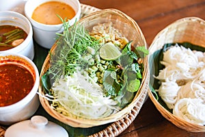 Thai rice vermicelli noodle with soup curry sauce and fresh vegetable set - Thai traditional menu