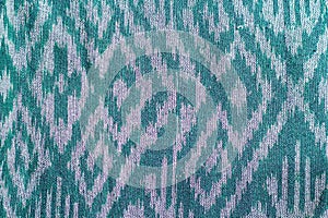 Thai's fabric pattern as background.