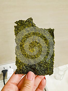 Thai seaweed snack unpacked hold in the hand in Thailand