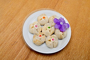 Thai shortbread cookies in plate on wooden background