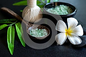 Thai spa composition treatments aroma therapy with candles and Plumeria flowers on wooden table close up.