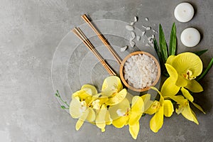 Thai Spa.  Hot stones setting for massage treatment and relax with yellow orchid on blackboard.