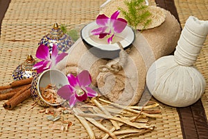 Thai spa massage setting , Massage oil, body scrub, Towels,Cinnamon sticks with orchids flower