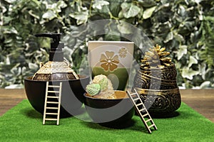 Thai spa set with cup of tea, ladder and green leaf background