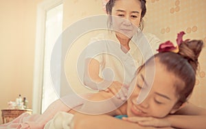 Thai Spa Therapist is kindly massaging woman back