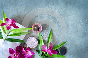 Thai Spa. Top view of hot stones setting for massage treatment and relax with purple orchid on blackboard with copy space.