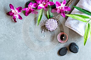Thai Spa. Top view of hot stones setting for massage treatment and relax with purple orchid on blackboard with copy space