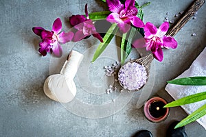 Thai Spa. Top view of hot stones setting for massage treatment and relax with purple orchid on blackboard with copy space.