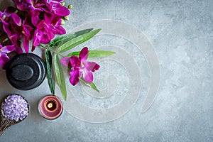 Thai Spa.  Top view of hot stones setting for massage treatment and relax with purple orchid on blackboard with copy space.  Green