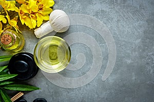 Thai Spa. Top view of hot stones setting for massage treatment and relax with yellow orchid on blackboard with copy space.