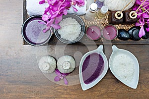 Thai Spa Treatments aroma therapy salt and nature sugar scrub and rock massage with orchid flower on wooden with candle. Thailand.