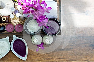 Thai Spa Treatments aroma therapy salt and sugar scrub and rock massage with orchid flower on wooden.