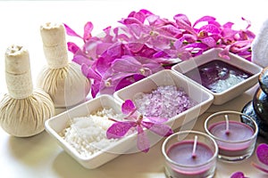 Thai Spa Treatments aroma therapy salt and sugar scrub and rock massage with orchid flower on wooden white. Healthy Concept.