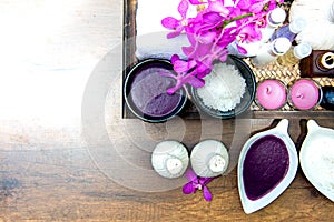 Thai Spa Treatments aroma therapy salt and sugar scrub and rock massage with orchid flower on wooden white.