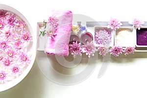 Thai Spa Treatments aroma therapy salt and sugar scrub and rock massage with pink flower on wooden white.