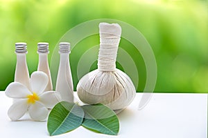 Thai Spa Treatments and massage flower on wooden white with green nature background.