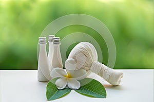 Thai Spa Treatments and massage flower on wooden white with green nature background