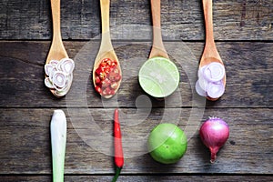 Thai Spicy ingredients (Tom-Yum) on wooden spoon with wooden table