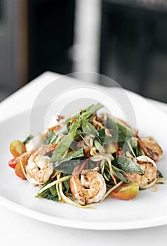 Thai spicy papaya salad with fresh prawns and basil