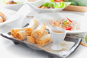 Thai spring rolls with sauce on dish
