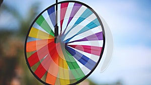 Thai street decoration. Close up of colorful spinner on blurred blue sky background. 1920x1080