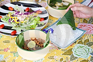 Thai street food. A photo of Thai street food served in vintage food carrier and tuna salad with soft focus on the jasmine rice