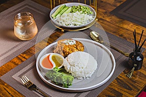 Thai street food, traditinal Thai omlete stuff minced pork for lunch time on wooden table background