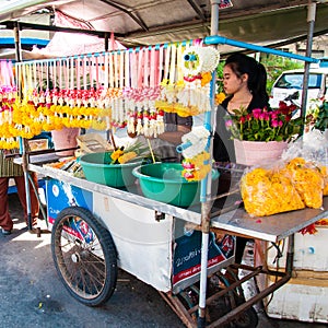 Thai Street vendor of flower garlands in Maeklong, Thailand.Flower garlands are widely used in
