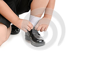 Thai student boy is tying the laces student shoe isolated